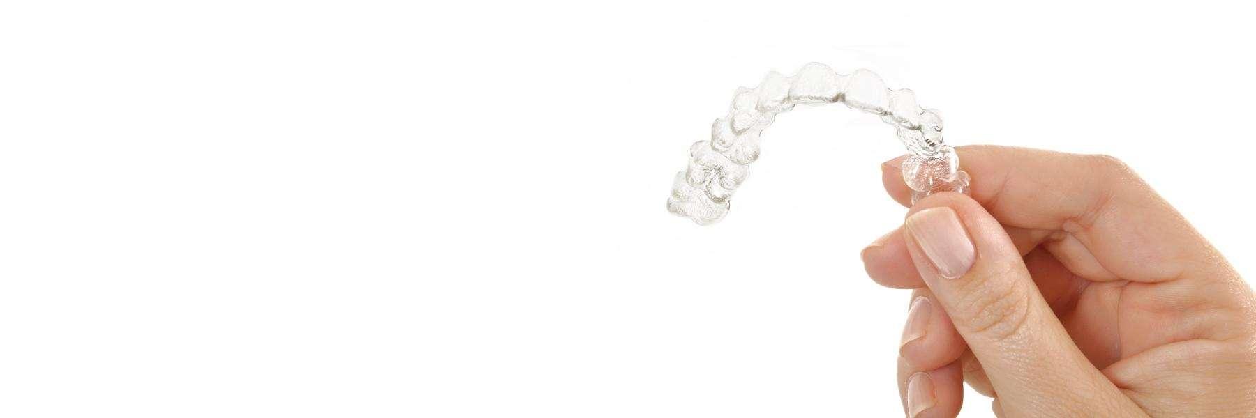 dentist holding clear aligners in concord nh