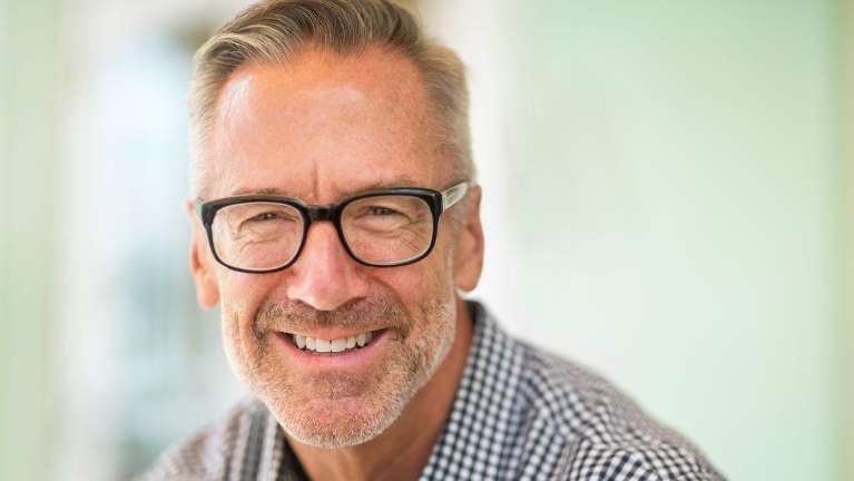 man with glasses smiling