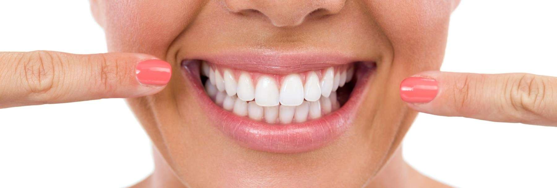 woman pointing at her teeth